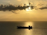 Dredge off Florida's Gold Coast at sunrise.